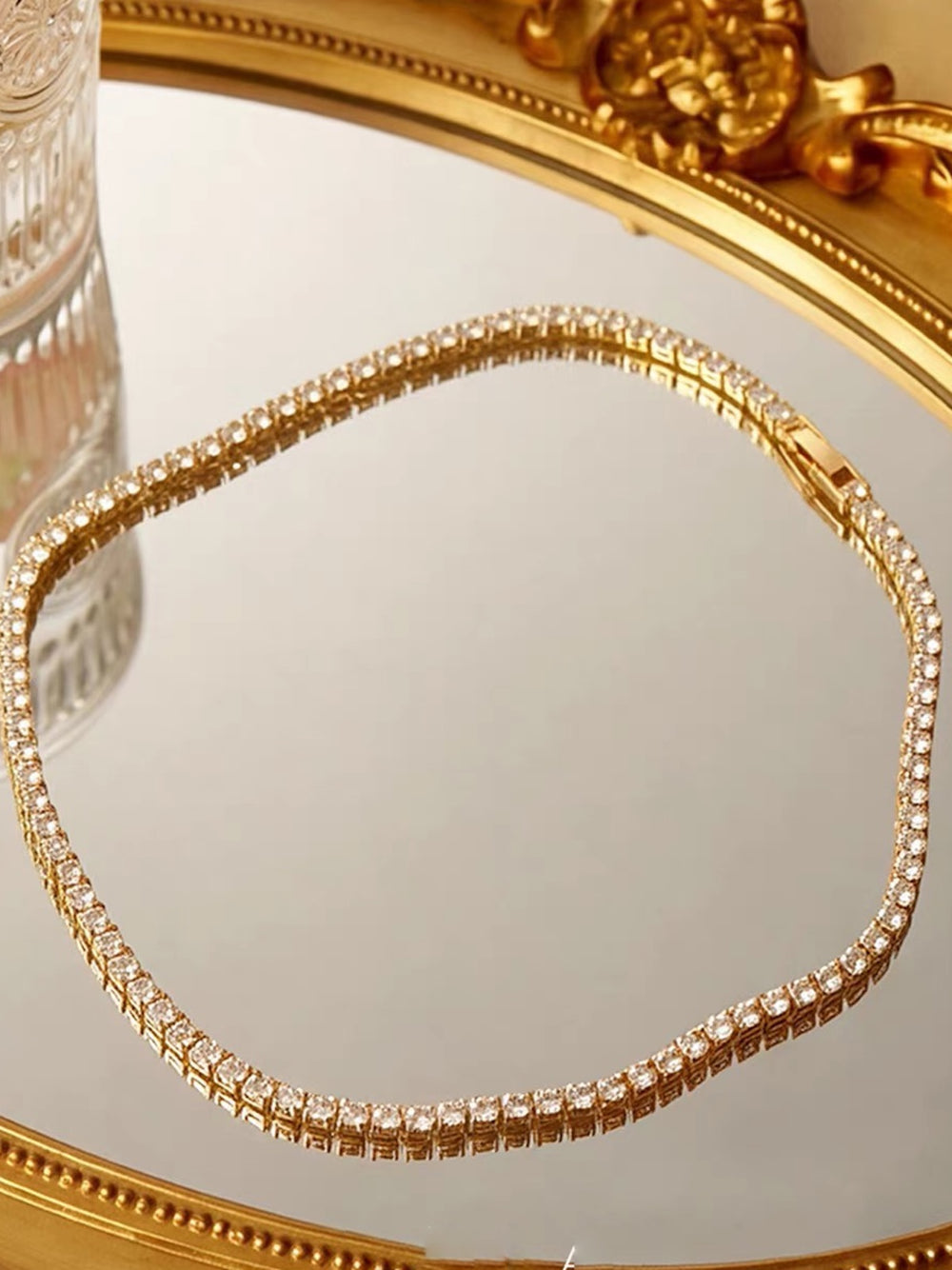 Timeless Diamond-Look Rivière Choker Necklace featuring a continuous row of brilliant diamond-look stones set in a gold-tone finish.
