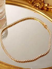 Timeless Diamond-Look Rivière Choker Necklace featuring a continuous row of brilliant diamond-look stones set in a gold-tone finish.
