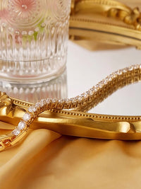 Timeless Diamond-Look Tennis Bracelet featuring a continuous row of premium-grade zirconia set in a classic gold-tone tennis bracelet design.