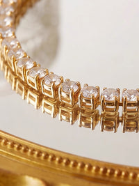 Timeless Diamond-Look Tennis Bracelet featuring a continuous row of premium-grade zirconia set in a classic gold-tone tennis bracelet design.