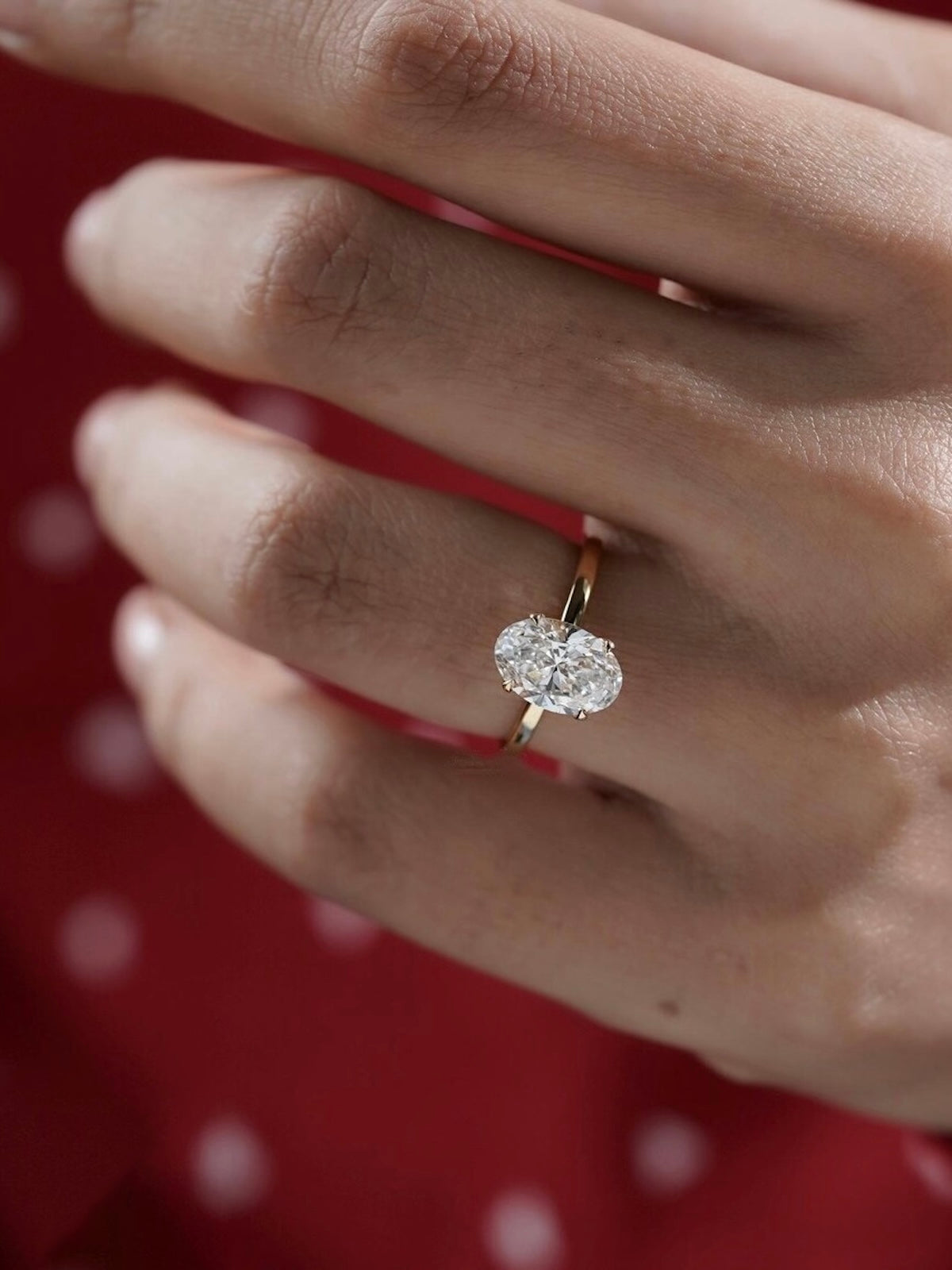 Éclat oval moissanite solitaire ring with VVS1 stone, four-prong setting and slender 14K gold-plated sterling silver band.