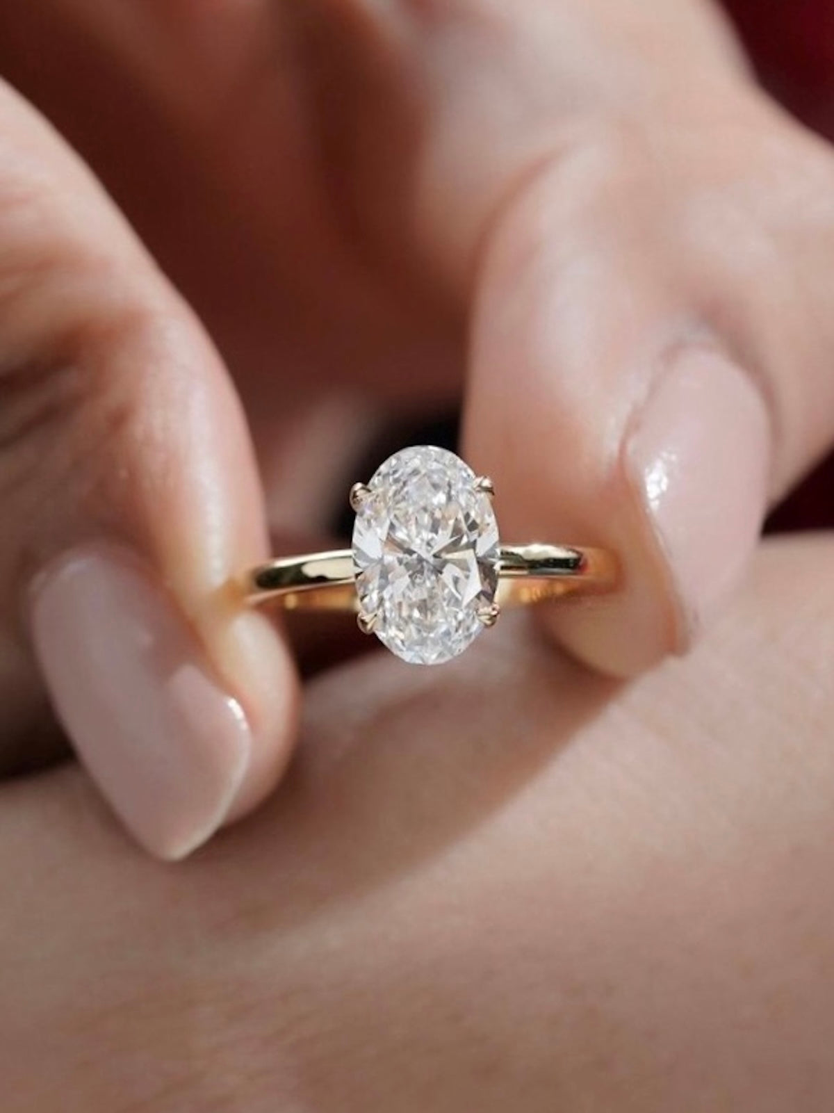 Éclat oval moissanite solitaire ring with VVS1 stone, four-prong setting and slender 14K gold-plated sterling silver band.