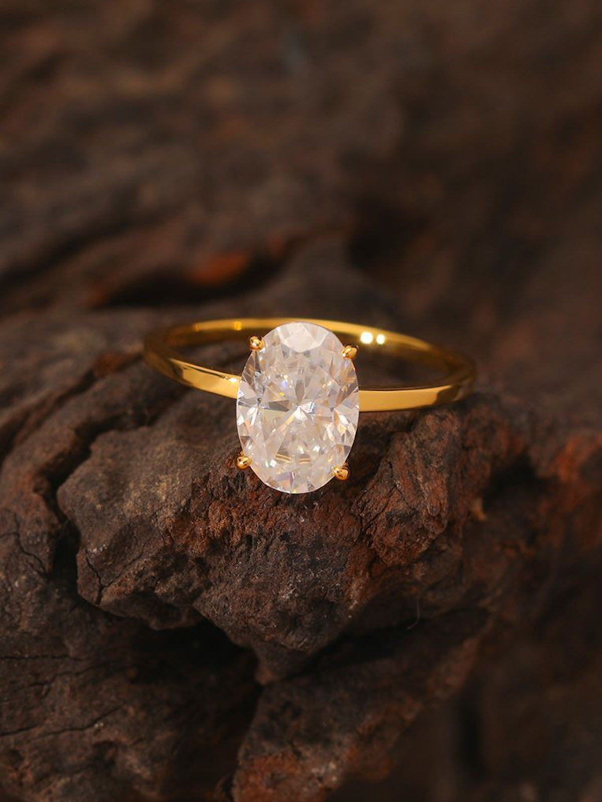 Éclat oval moissanite solitaire ring with VVS1 stone, four-prong setting and slender 14K gold-plated sterling silver band.