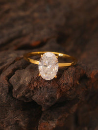 Éclat oval moissanite solitaire ring with VVS1 stone, four-prong setting and slender 14K gold-plated sterling silver band.