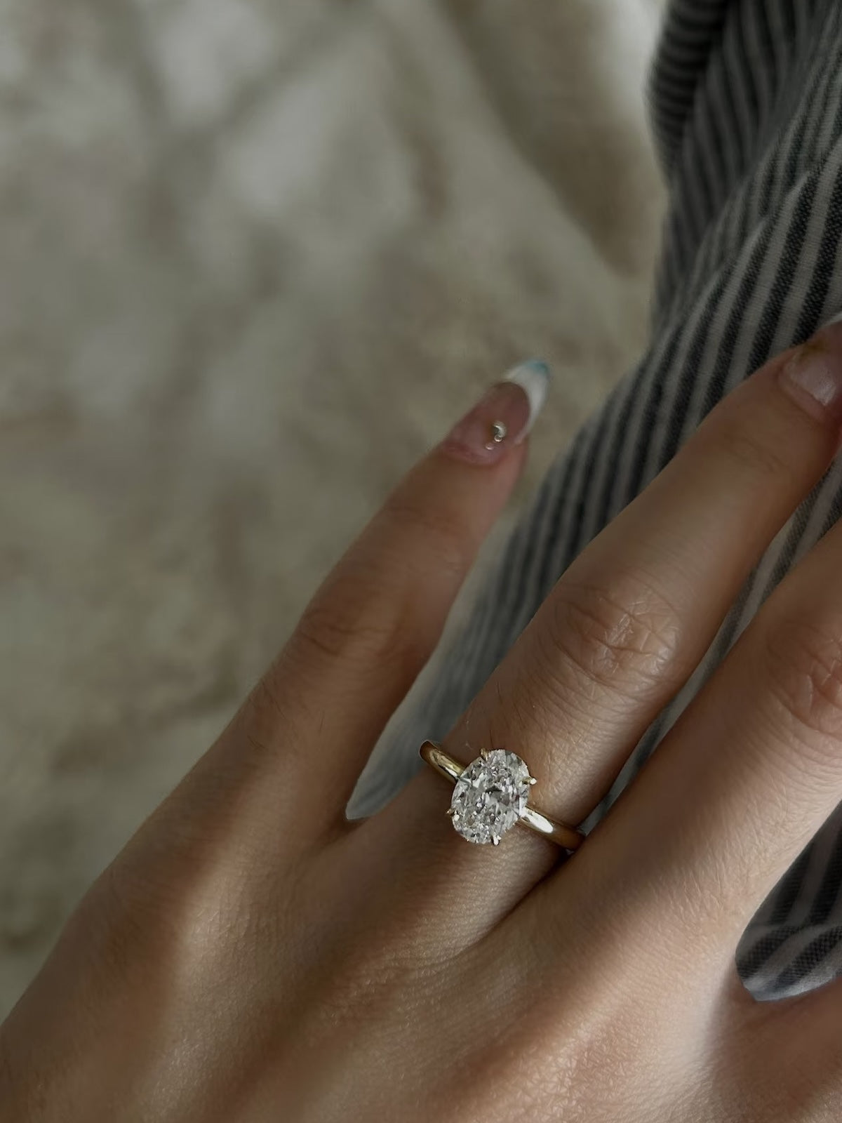 Éclat oval moissanite solitaire ring with VVS1 stone, four-prong setting and slender 14K gold-plated sterling silver band.