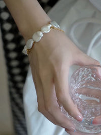 Luminous Baroque Pearl Coin Beads Bracelet with irregular freshwater baroque pearls and delicate golden chain details.