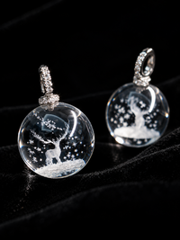 Clear Quartz Reindeer Necklace featuring a genuine clear quartz crystal pendant with a delicate reindeer motif suspended from a sterling silver chain.