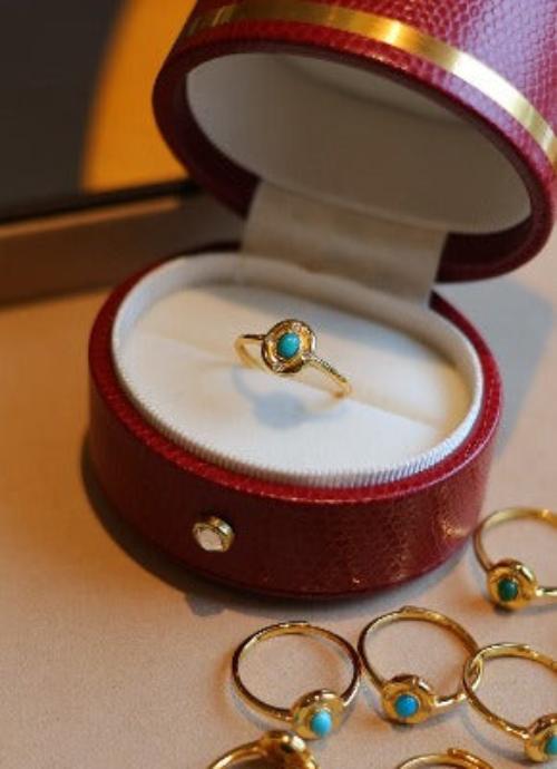 Vintage Turquoise Solitaire Ring featuring a genuine oval turquoise gemstone set within an ornate gold vermeil adjustable band.
