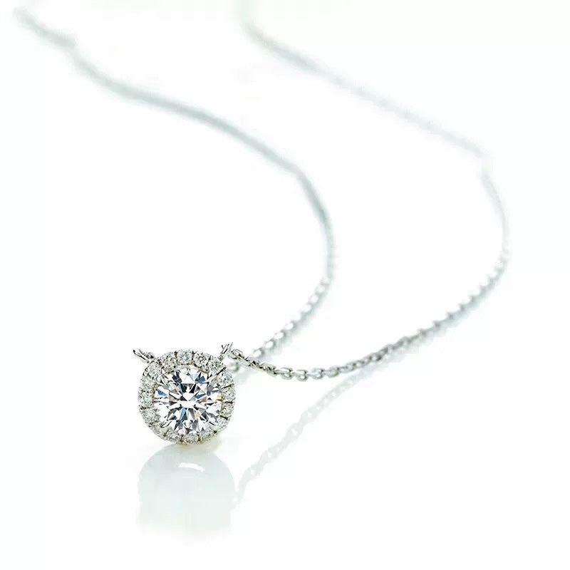 Sparkling Moissanite Halo Necklace featuring a round brilliant moissanite surrounded by a halo of accent stones in a sterling silver setting.