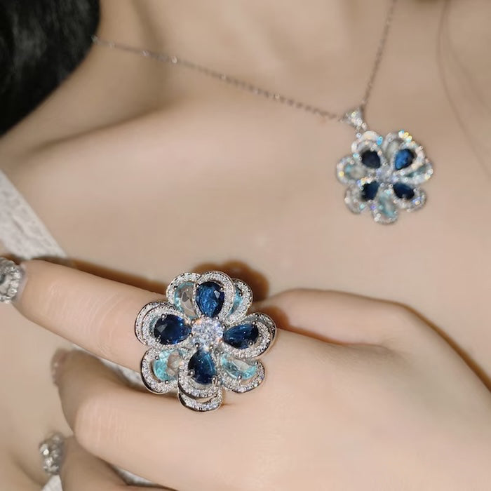 Azure Oil Painting Floral Jewelry Set featuring sapphire-blue and aqua crystal flowers with sparkling premium-grade zirconia in a matching pendant necklace, stud earrings, and adjustable ring.