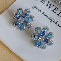 Azure Oil Painting Floral Jewelry Set featuring sapphire-blue and aqua crystal flowers with sparkling premium-grade zirconia in a matching pendant necklace, stud earrings, and adjustable ring.
