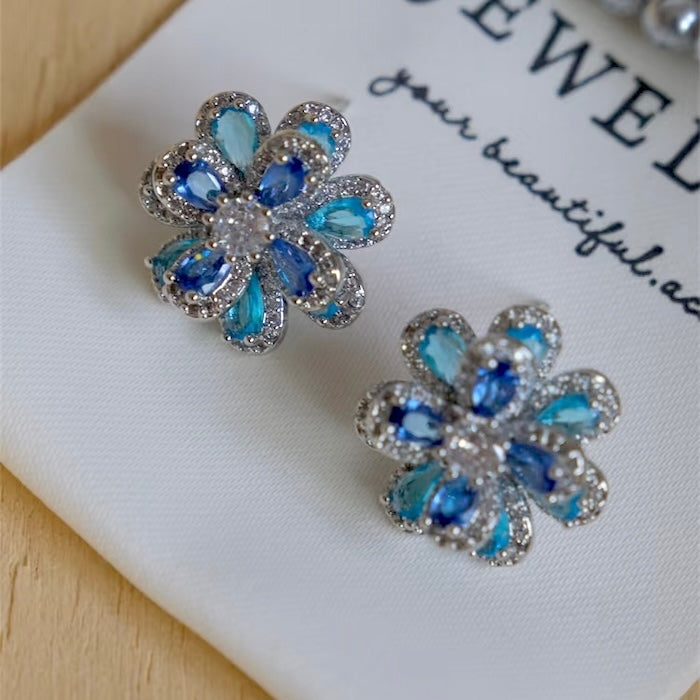 Azure Oil Painting Floral Jewelry Set featuring sapphire-blue and aqua crystal flowers with sparkling premium-grade zirconia in a matching pendant necklace, stud earrings, and adjustable ring.