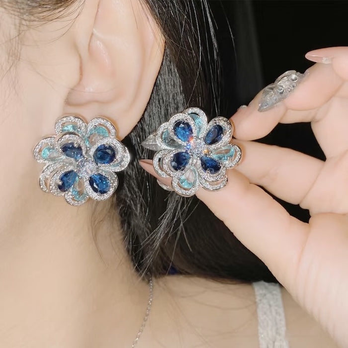 Azure Oil Painting Floral Jewelry Set featuring sapphire-blue and aqua crystal flowers with sparkling premium-grade zirconia in a matching pendant necklace, stud earrings, and adjustable ring.