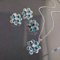 Azure Oil Painting Floral Jewelry Set featuring sapphire-blue and aqua crystal flowers with sparkling premium-grade zirconia in a matching pendant necklace, stud earrings, and adjustable ring.