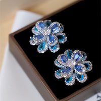 Azure Oil Painting Floral Jewelry Set featuring sapphire-blue and aqua crystal flowers with sparkling premium-grade zirconia in a matching pendant necklace, stud earrings, and adjustable ring.