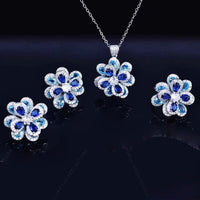 Azure Oil Painting Floral Jewelry Set featuring sapphire-blue and aqua crystal flowers with sparkling premium-grade zirconia in a matching pendant necklace, stud earrings, and adjustable ring.
