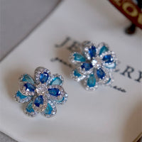 Azure Oil Painting Floral Jewelry Set featuring sapphire-blue and aqua crystal flowers with sparkling premium-grade zirconia in a matching pendant necklace, stud earrings, and adjustable ring.