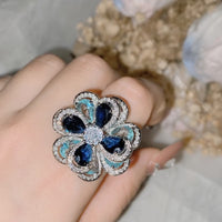 Azure Oil Painting Floral Jewelry Set featuring sapphire-blue and aqua crystal flowers with sparkling premium-grade zirconia in a matching pendant necklace, stud earrings, and adjustable ring.