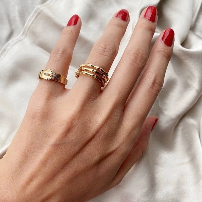 Layered Bamboo Style Adjustable Ring featuring multiple bamboo-inspired gold-tone bands stacked into a bold adjustable ring design.
