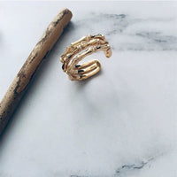Layered Bamboo Style Adjustable Ring featuring multiple bamboo-inspired gold-tone bands stacked into a bold adjustable ring design.

