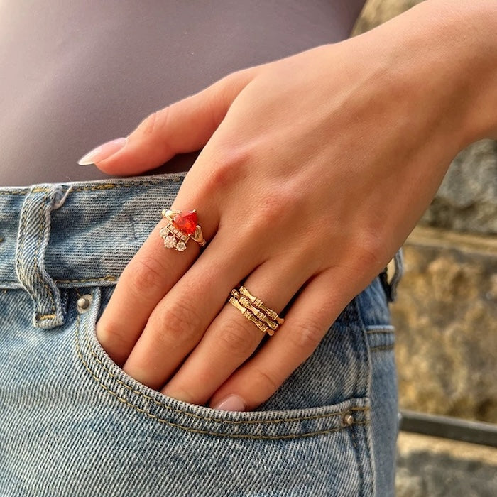 Layered Bamboo Style Adjustable Ring featuring multiple bamboo-inspired gold-tone bands stacked into a bold adjustable ring design.
