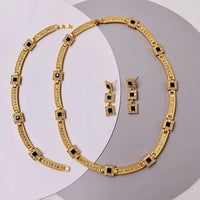 Vintage Style Geometric Black Onyx Jewelry Set featuring geometric black stones and sparkling zirconia accents in a gold-tone necklace and matching earrings.
