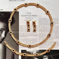 Vintage Style Geometric Black Onyx Jewelry Set featuring geometric black stones and sparkling zirconia accents in a gold-tone necklace and matching earrings.
