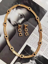 Vintage Style Geometric Black Onyx Jewelry Set featuring geometric black stones and sparkling zirconia accents in a gold-tone necklace and matching earrings.
