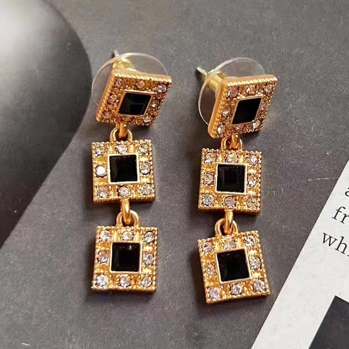 Vintage Style Geometric Black Onyx Jewelry Set featuring geometric black stones and sparkling zirconia accents in a gold-tone necklace and matching earrings.
