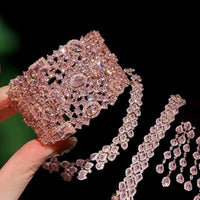 Blush Diamond Couture Jewelry Set featuring an open rose gold-plated cuff bangle, matching tennis bracelet, and cascading chandelier earrings adorned with brilliant blush pink stones.