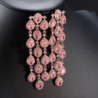 Blush Diamond Couture Jewelry Set featuring an open rose gold-plated cuff bangle, matching tennis bracelet, and cascading chandelier earrings adorned with brilliant blush pink stones.