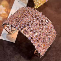 Blush Diamond Couture Jewelry Set featuring an open rose gold-plated cuff bangle, matching tennis bracelet, and cascading chandelier earrings adorned with brilliant blush pink stones.