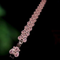 Blush Diamond Couture Jewelry Set featuring an open rose gold-plated cuff bangle, matching tennis bracelet, and cascading chandelier earrings adorned with brilliant blush pink stones.