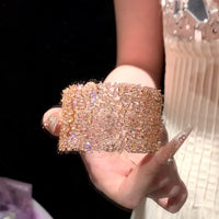 Blush Diamond Couture Jewelry Set featuring an open rose gold-plated cuff bangle, matching tennis bracelet, and cascading chandelier earrings adorned with brilliant blush pink stones.