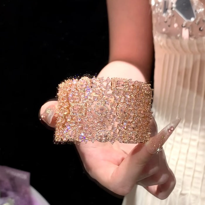 Blush Diamond Couture Jewelry Set featuring an open rose gold-plated cuff bangle, matching tennis bracelet, and cascading chandelier earrings adorned with brilliant blush pink stones.