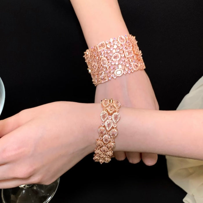 Blush Diamond Couture Jewelry Set featuring an open rose gold-plated cuff bangle, matching tennis bracelet, and cascading chandelier earrings adorned with brilliant blush pink stones.