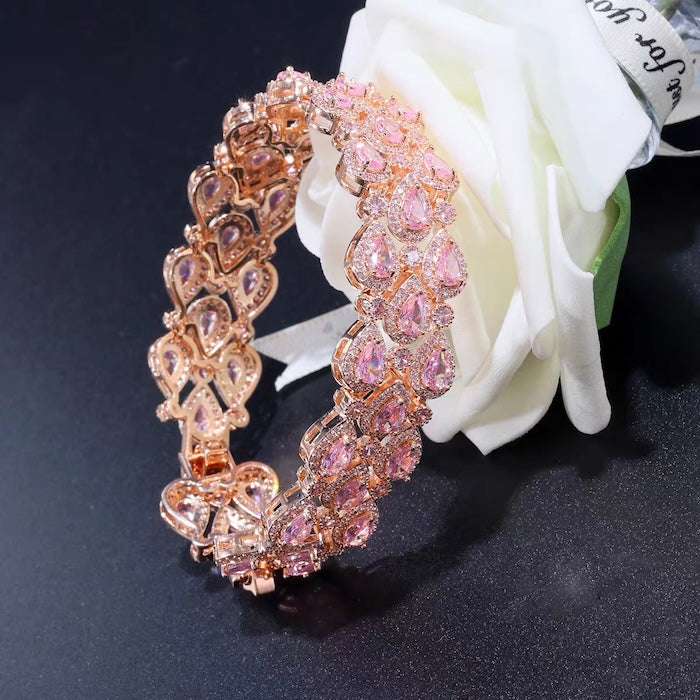 Blush Diamond Couture Jewelry Set featuring an open rose gold-plated cuff bangle, matching tennis bracelet, and cascading chandelier earrings adorned with brilliant blush pink stones.