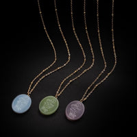 Vintage Botanical Mother of Pearl Medallion Necklace with an engraved floral pendant in powder blue, sage green, or lavender on a gold-plated stainless steel chain.
