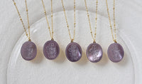 Vintage Botanical Mother of Pearl Medallion Necklace with an engraved floral pendant in powder blue, sage green, or lavender on a gold-plated stainless steel chain.
