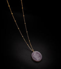 Vintage Botanical Mother of Pearl Medallion Necklace with an engraved floral pendant in powder blue, sage green, or lavender on a gold-plated stainless steel chain.
