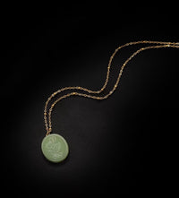 Vintage Botanical Mother of Pearl Medallion Necklace with an engraved floral pendant in powder blue, sage green, or lavender on a gold-plated stainless steel chain.

