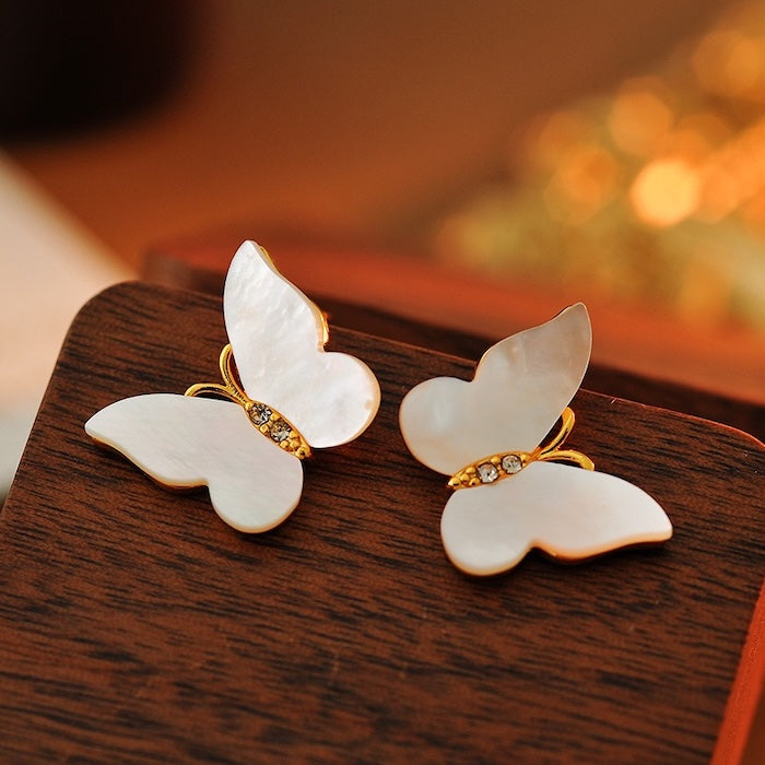 Iridescent Butterfly Shell Stud Earrings featuring luminous shell wings and delicate zirconia accents in a butterfly-inspired gold-tone design.