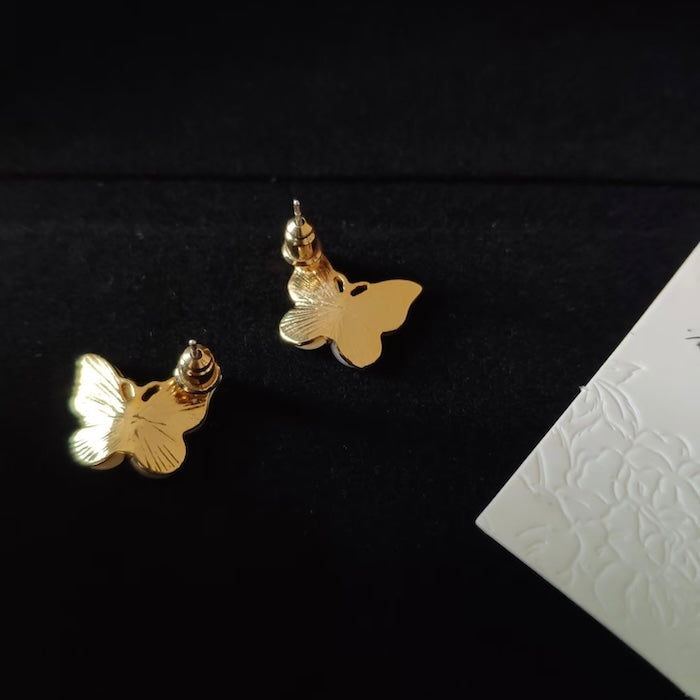 Iridescent Butterfly Shell Stud Earrings featuring luminous shell wings and delicate zirconia accents in a butterfly-inspired gold-tone design.