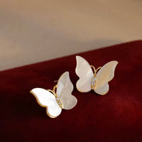 Iridescent Butterfly Shell Stud Earrings featuring luminous shell wings and delicate zirconia accents in a butterfly-inspired gold-tone design.