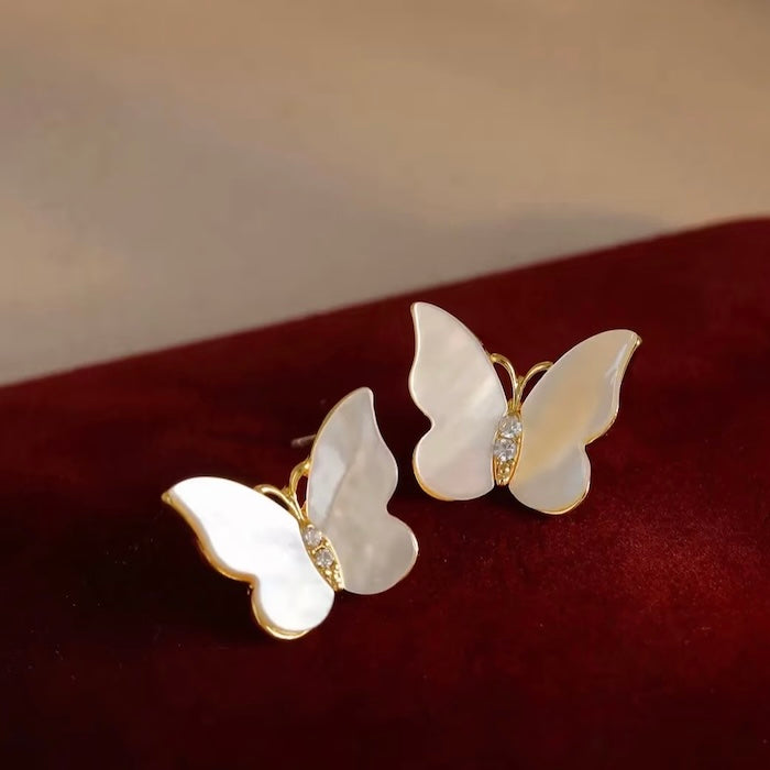 Iridescent Butterfly Shell Stud Earrings featuring luminous shell wings and delicate zirconia accents in a butterfly-inspired gold-tone design.