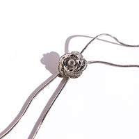 Sophisticated Silver Camellia Necklace and Earrings Set featuring delicate camellia-inspired floral details in a silver-plated finish with matching earrings.
