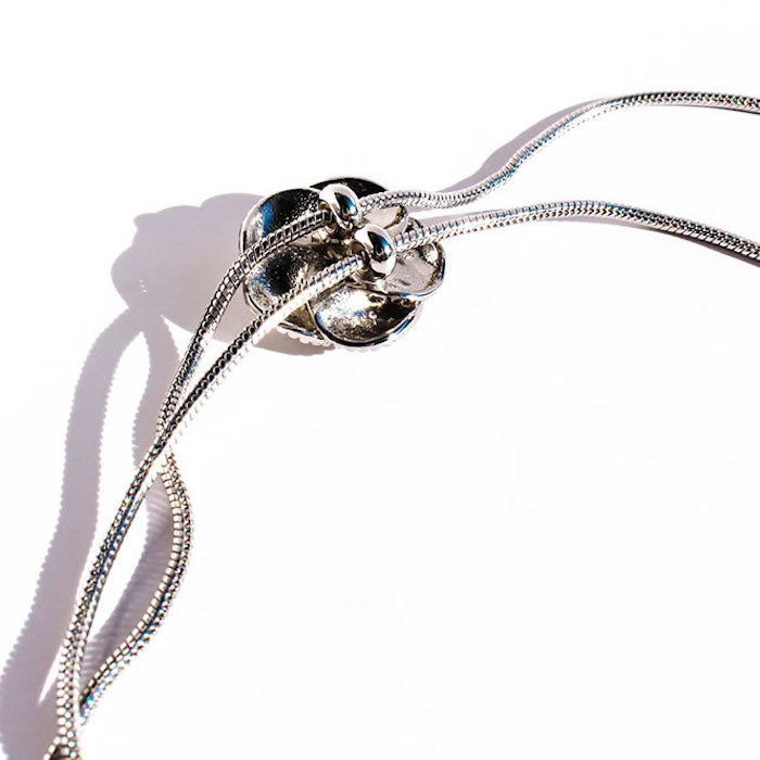 Sophisticated Silver Camellia Necklace and Earrings Set featuring delicate camellia-inspired floral details in a silver-plated finish with matching earrings.
