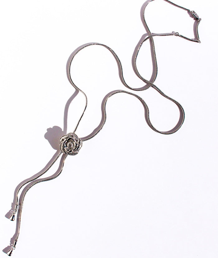 Sophisticated Silver Camellia Necklace and Earrings Set featuring delicate camellia-inspired floral details in a silver-plated finish with matching earrings.
