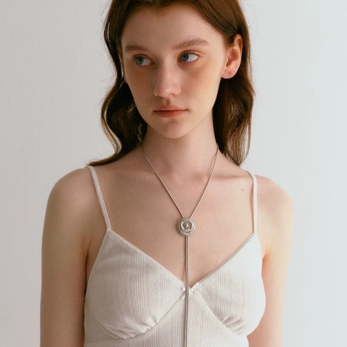 Sophisticated Silver Camellia Necklace and Earrings Set featuring delicate camellia-inspired floral details in a silver-plated finish with matching earrings.
