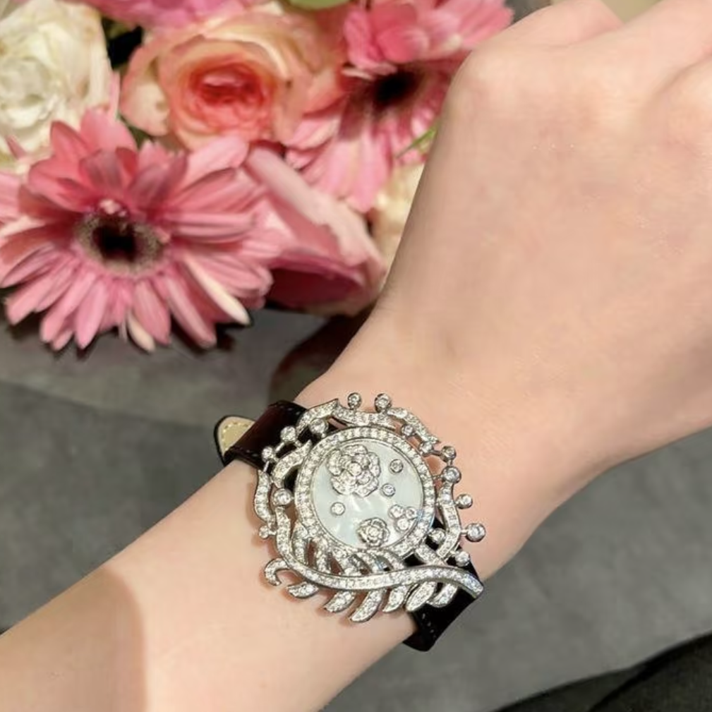 Camellia Convertible Watch Style Bracelet featuring a detachable mother-of-pearl and premium-grade zirconia centerpiece on a black PU leather strap with a luxurious watch-inspired design.